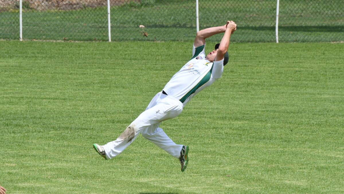 SAFE HANDS: Adam Ryan, pictured taking a catch in the WZPL final, and Bathurst's district side had a memorable season. Photo: CHRIS SEABROOK