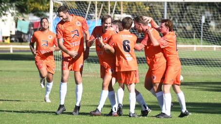 Jake Grady (second from left) celebrates with his new Dubbo FC teammates during the win over Macquarie. Picture by Tom Barber