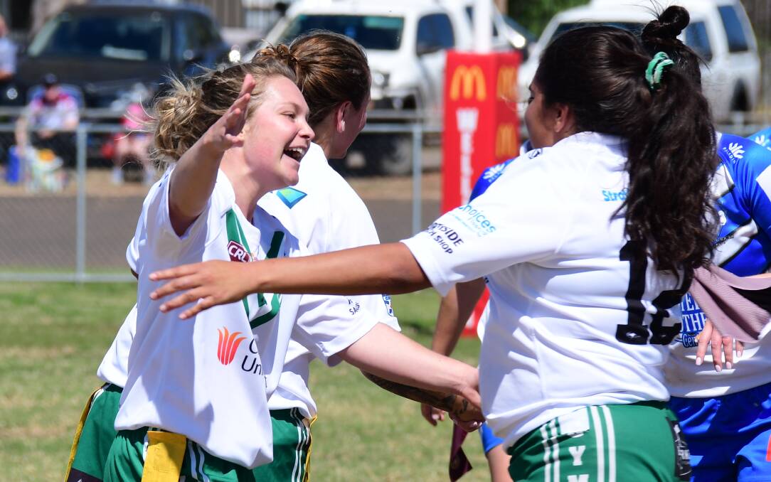 WINNING FEELING: Haley Butcherine (left) celebrates Sunday's victory with Cassie Toomey. Photo: NICK GUTHRIE