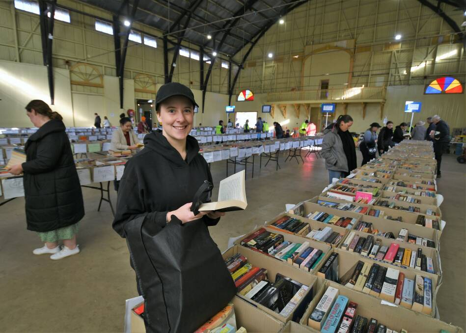 A BOOKWORM'S PARADISE: Natalie Hock unearthed some interesting reads at the Lifeline Book Fair. Photo: CHRIS SEABROOK 051521cbksfair8