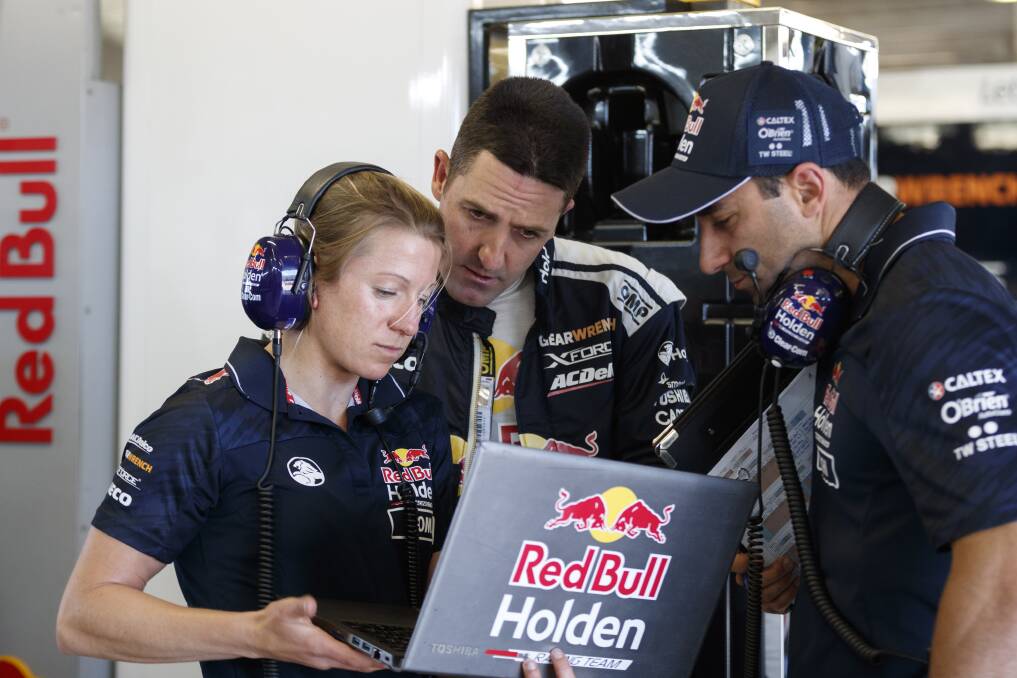 A TEAM EFFORT: Triple Eight Race Engineering data engineer Romy Mayer, seen working with driver Jamie Whincup and his race engineer, David Cauchi. Photo: MARK HORSBURGH, VUE IMAGES