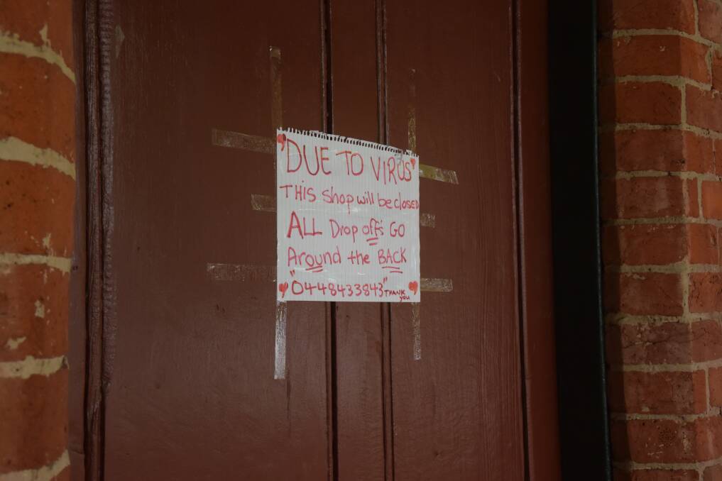 The sign left on the door of the op shop. 
