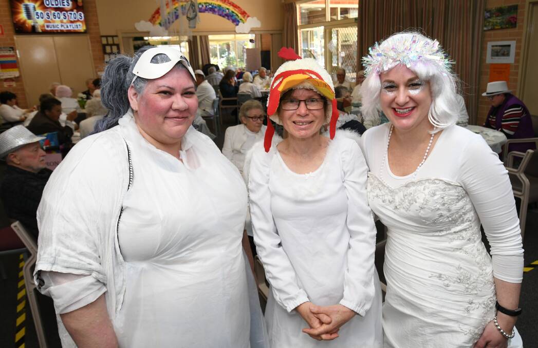 GOING STRONG: Bathurst Seymour Centre staff members Melanie Trudgett, Terisa Ashworth and Rachael Burnett, dressed in white for the 40th birthday celebrations on Wednesday. Photo: CHRIS SEABROOK 080719cseymr1