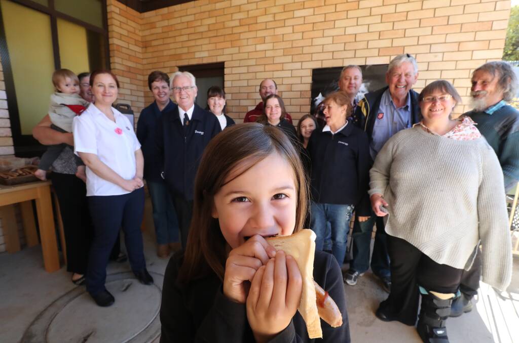 HELPED: Seven-year-old Lillie Kilby and other Salvation Army volunteers enjoying a barbecue lunch on Sunday. Photo: PHIL BLATCH 052619pbsalvo1