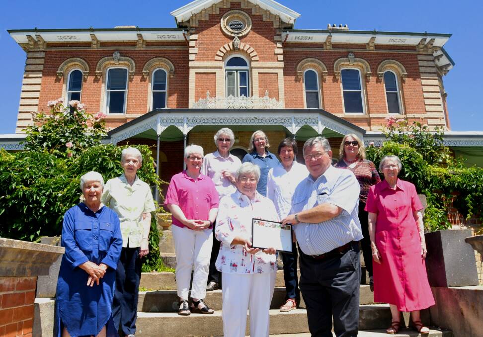 PRESENTATION: Sister Patricia Powell and the Sisters of Mercy receiving the award from Iain McPherson and members of the National Trust. 