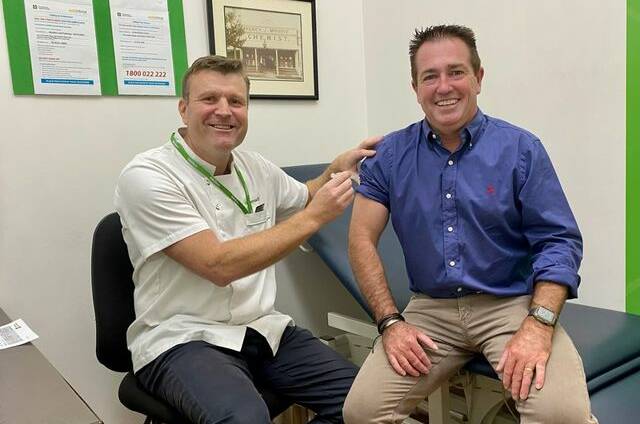 SHOT IN THE ARM: Pharmacist Paul Jones giving Member for Bathurst Paul Toole his flu shot at Moodie's Pharmacy. Photo: SUPPLIED