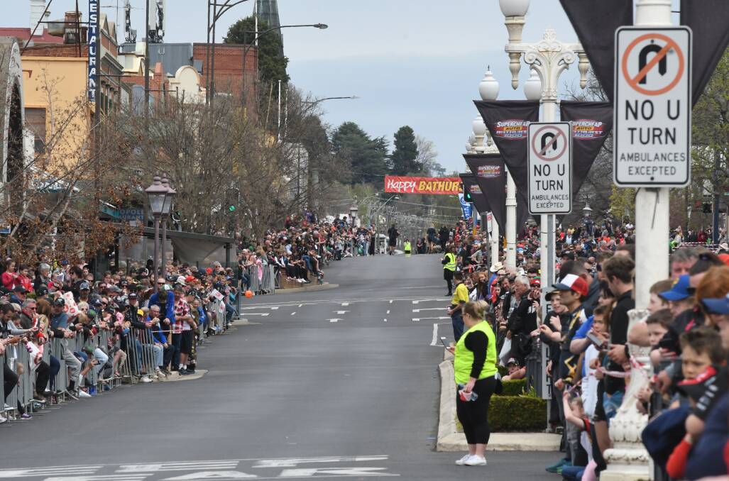 GONE TOO SOON: Race fans crowd the streets for the parade, but then start to head back to the Mount, one business owner said. Photo: CHRIS SEABROOK