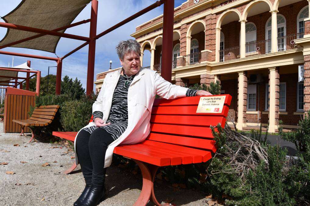 BEACON: Councillor Jacqui Rudge is pleased to have a red bench in a high-profile area like Haymarket Reserve. Photo: RACHEL CHAMBERLAIN