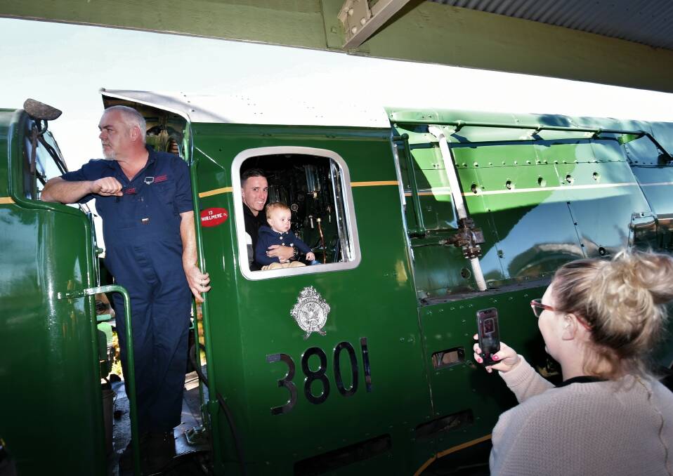 PHOTO MEMOTO: Shae Gillbanks takes a photo of her son, Keaton, with his dad, Tony, in the cab of the 3801. Photo: CHRIS SEABROOK 060621ctrain1