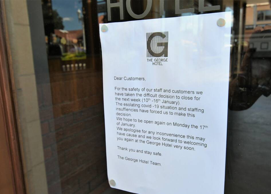 AFFECTED: A sign on the door of The George Hotel, explaining its closure. Photo: CHRIS SEABROOK