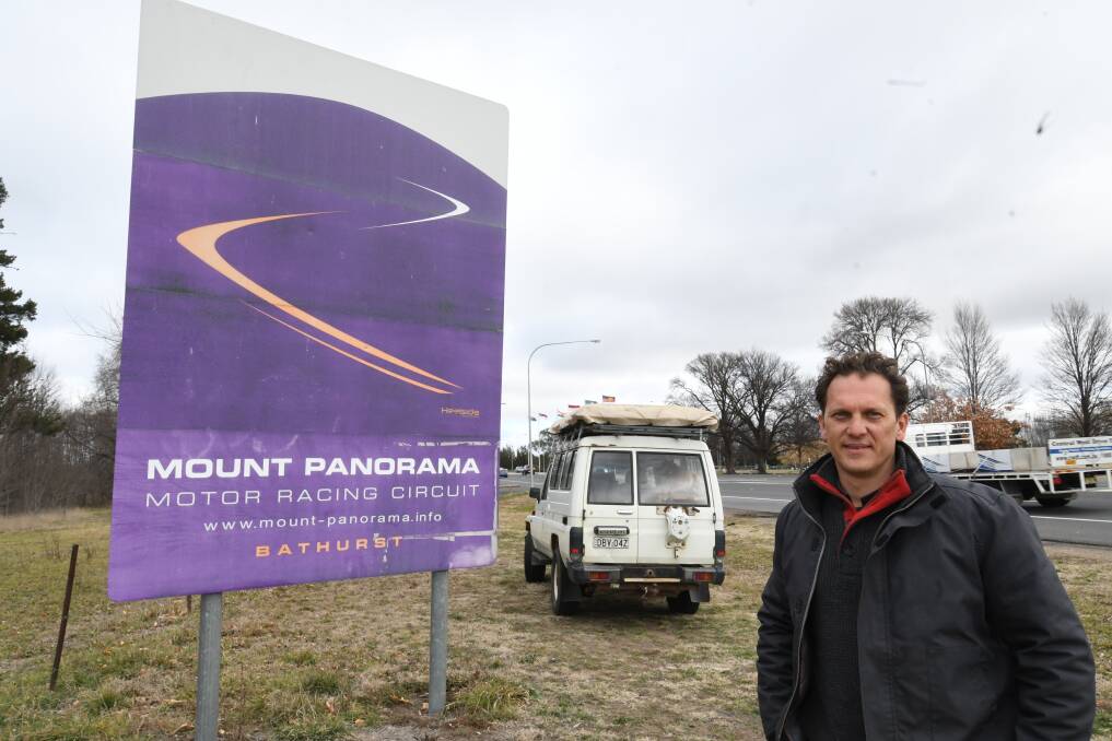 REVAMP: Councillor Jess Jennings pictured near Evans Bridge, where a faded Mount Panorama sign sits. He wants to see the sign replaced and later tie in with the new entrance statement. Photo: CHRIS SEABROOK 081318csign1