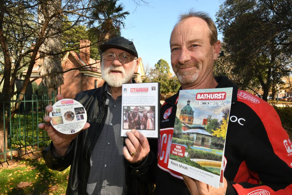PRECIOUS MEMORIES: Bruce Ryan and John Telfer of Bathurst Remembers with one of their new releases. Photo: CHRIS SEABROOK 061119cbxhistry