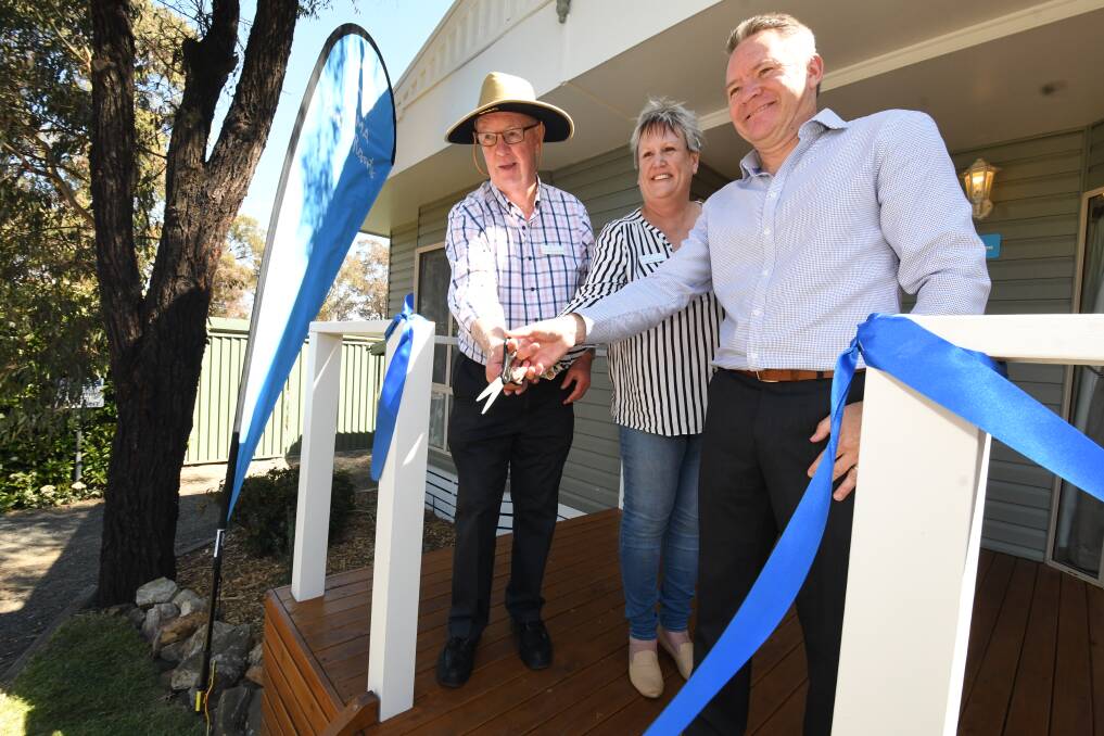 OPEN FOR BUSINESS: Mayor Graeme Hanger, councillor Jacqui Rudge and NRMA Parks and Resorts CEO Paul Davies cutting the ribbon on Wednesday. 