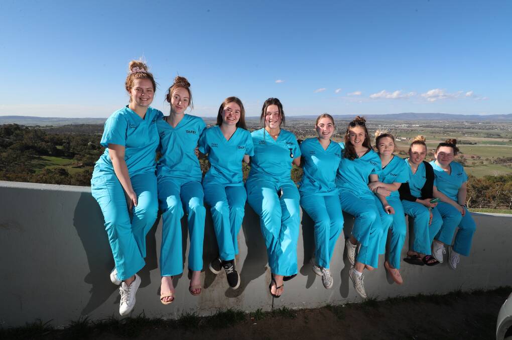 SNAPSHOT: Bathurst High Year 12 students celebrated on the mount after finishing their Assistance in Nursing TAFE course. Photo: PHIL BLATCH