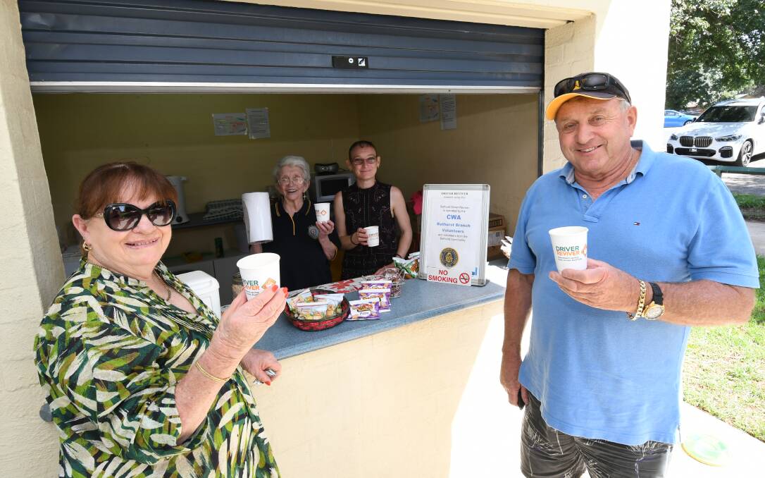 CUPPA TIME: Colleen and Peter Miller, from Forbes, being served at the driver reviver by volunteers Dorothy McNeill and Karleen Engelbrecht. Photo: CHRIS SEABROOK 012720cdrivrevr
