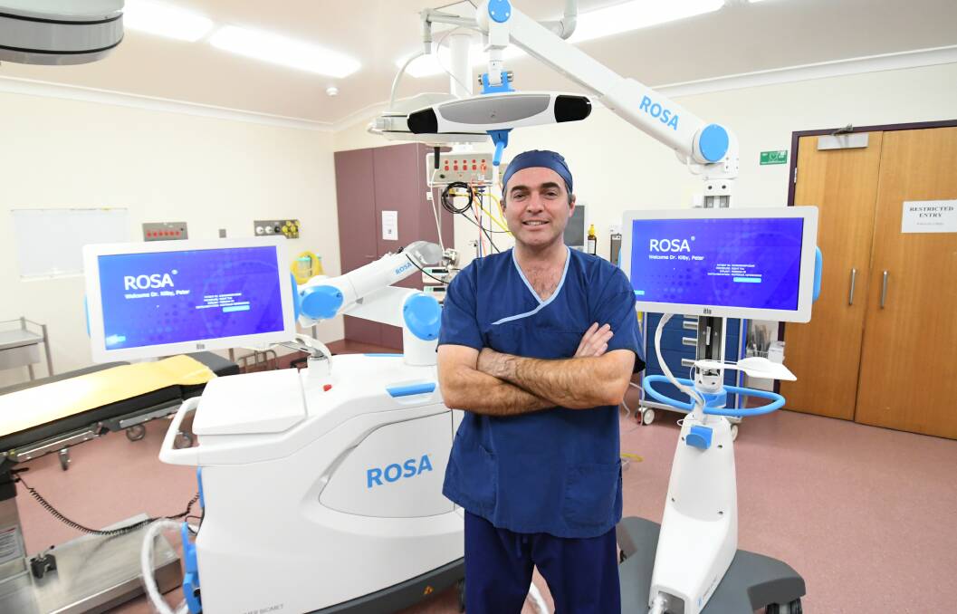 NEW TECHNOLOGY: Orthopaedic surgeon Dr Peter Kilby with the ROSA Knee System at the private hospital. Photo: CHRIS SEABROOK 070620crosa1
