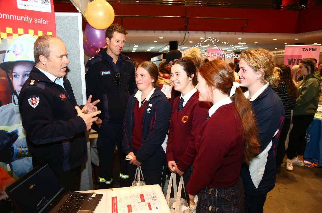 FLASHBACK: Superintendent Brett Jackson and station officer Doug Fisk speaking to MacKillop College students at the 2017 Bathurst Jobs Expo. Photo: PHIL BLATCH