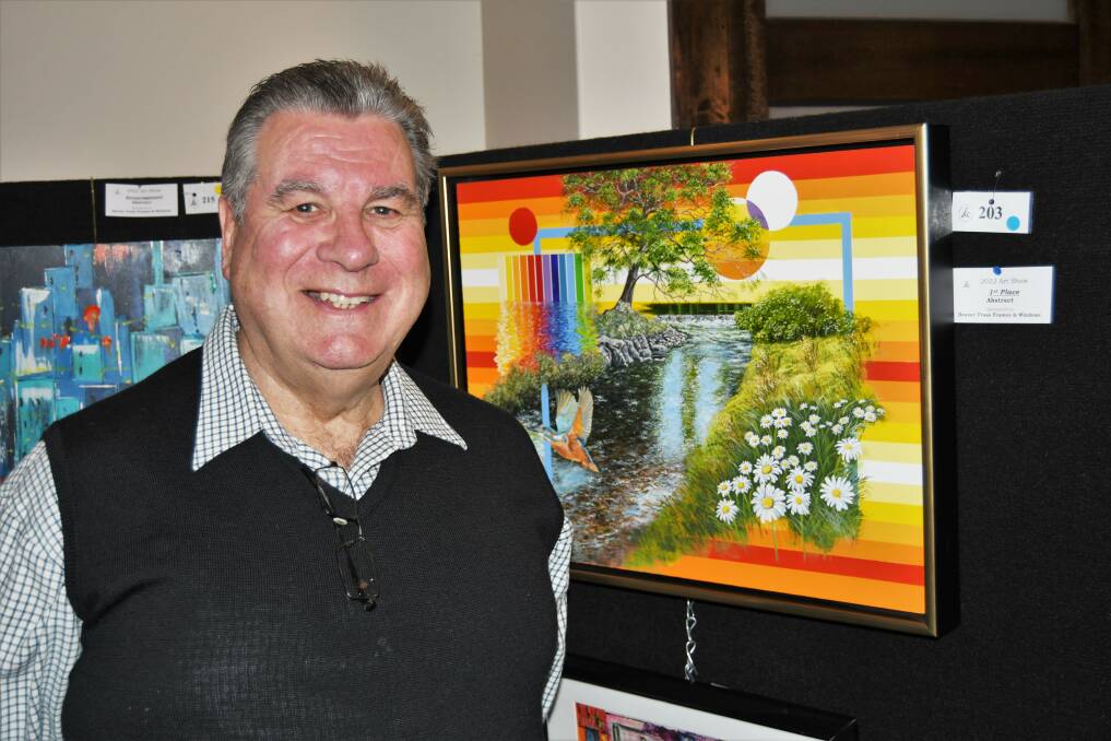 Artist David Young with his piece, Juxtaposition, which received first prize in the abstract section of the Evans Arts Council Art Competition and Sale. Photo: CHRIS SEABROOK