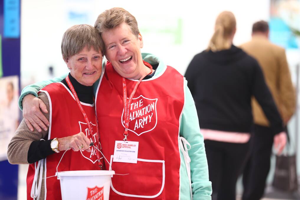 HAPPY TO HELP: Volunteers Edie Clifton and Fay Foster, who collected money for the Red Shield Appeal at Bathurst Stocklands on Saturday. Photo: PHIL BLATCH 052618pbred1