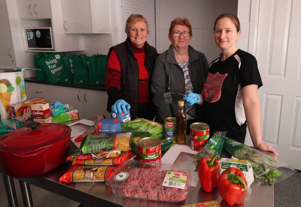 COOKING: Uniting Safe Shelter coordinator Julie Greig with Lynda Couchman and Salvation Army Lieutenant Kate Cathcart. Photo: PHIL BLATCH 050119pbcook1