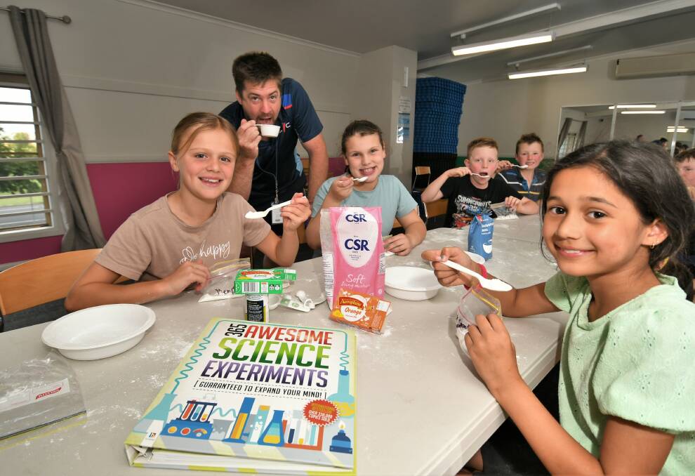 FUN: Memphis Johnson, 10, Charli Bowden,10, and Melissa Doyle, 9, with Bathurst PCYC manager Dave Hitchick, showing the sherbet they made. Photo:CHRIS SEABROOK 040621cpcyc1
