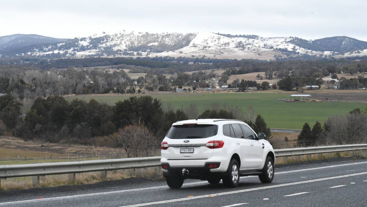 SNAPSHOT: This car, heading towards O'Connell, had a scenic journey ahead thanks to snow covered hills in the distance. Photo: CHRIS SEABROOK