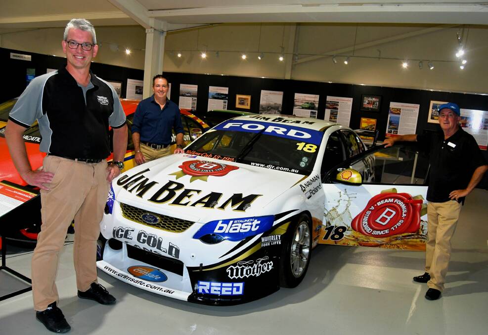 NEW ADDITION: Manager of the museum, Brad Owen, Member for Bathurst Paul Toole and mayor Bobby Bourke with the Ford FG Falcon driven by James Courtney. Photo: RACHEL CHAMBERLAIN