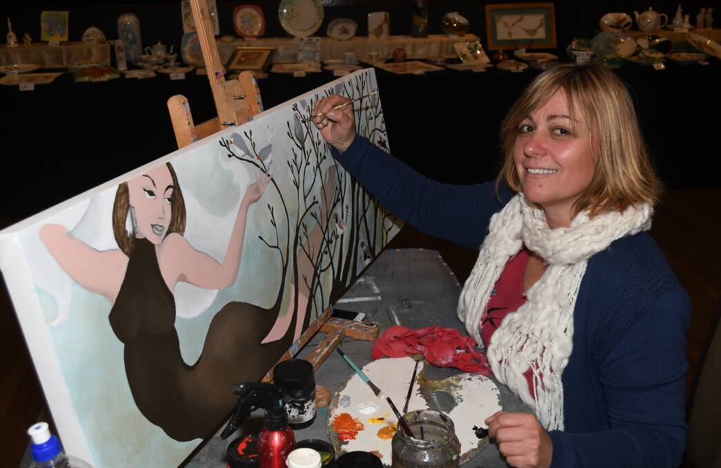 TALENTED: Guest Artist Tanya Loviz started painting this piece at the Evans Arts Council show on Saturday. Photo: CHRIS SEABROOK 080518cevart