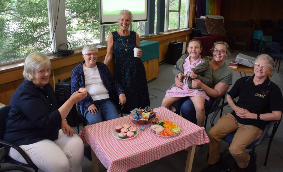 AFTERNOON TEA: Some of the volunteers from the Uniting Safe Shelter with the Bathurt Uniting Church reverend Claire Wright (standing). Photo: RACHEL CHAMBERLAIN 10241rcuss