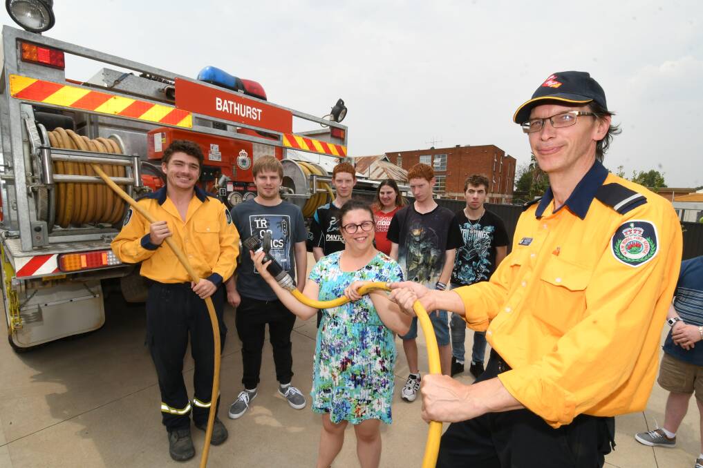 MEET AND GREET: Volunteer firefighter Anthony Coan, Vivability client Phoebe Said and NSW RFS Bathurst brigade deputy captain George Nicholls. 011520cfood2