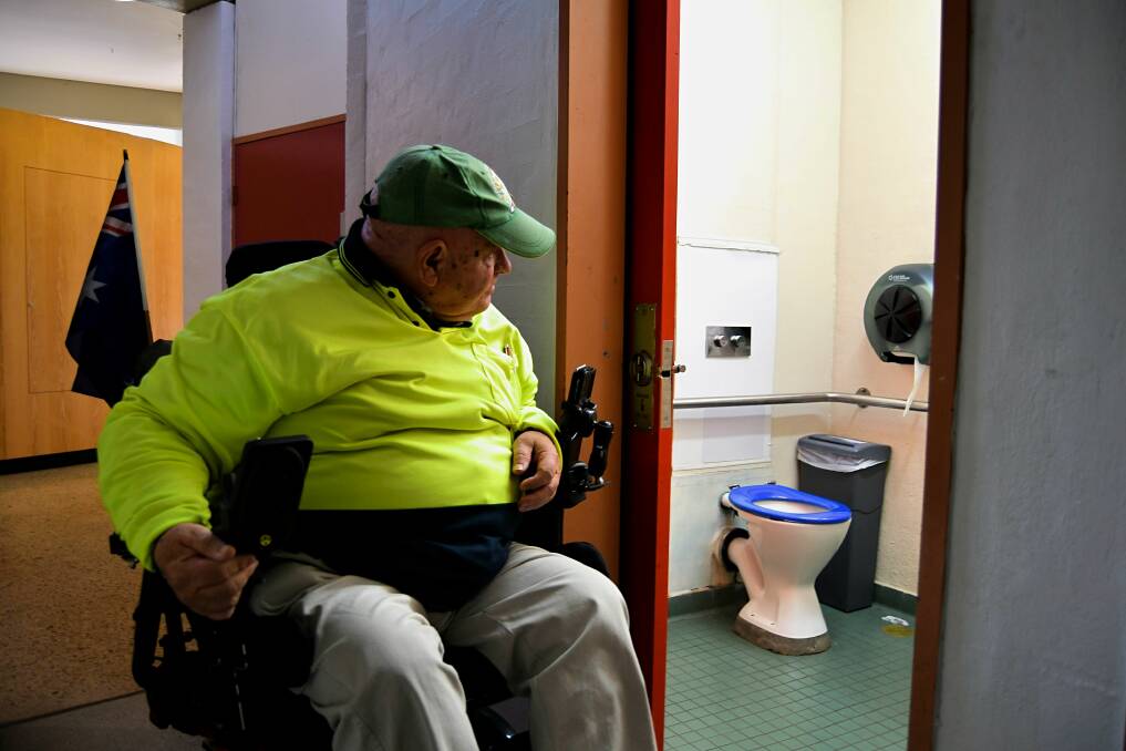 Disability advocate Bob Triming at the existing disabled toilet at Bathurst Library. Photo: RACHEL CHAMBERLAIN