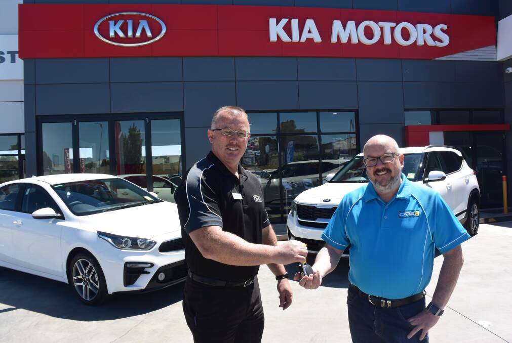JUST PURCHASED: Clancy Motors sales manager Kevin Burke handing the keys over to Matthew Irvine for his new Kia Cerato and Kia Seltos. 
