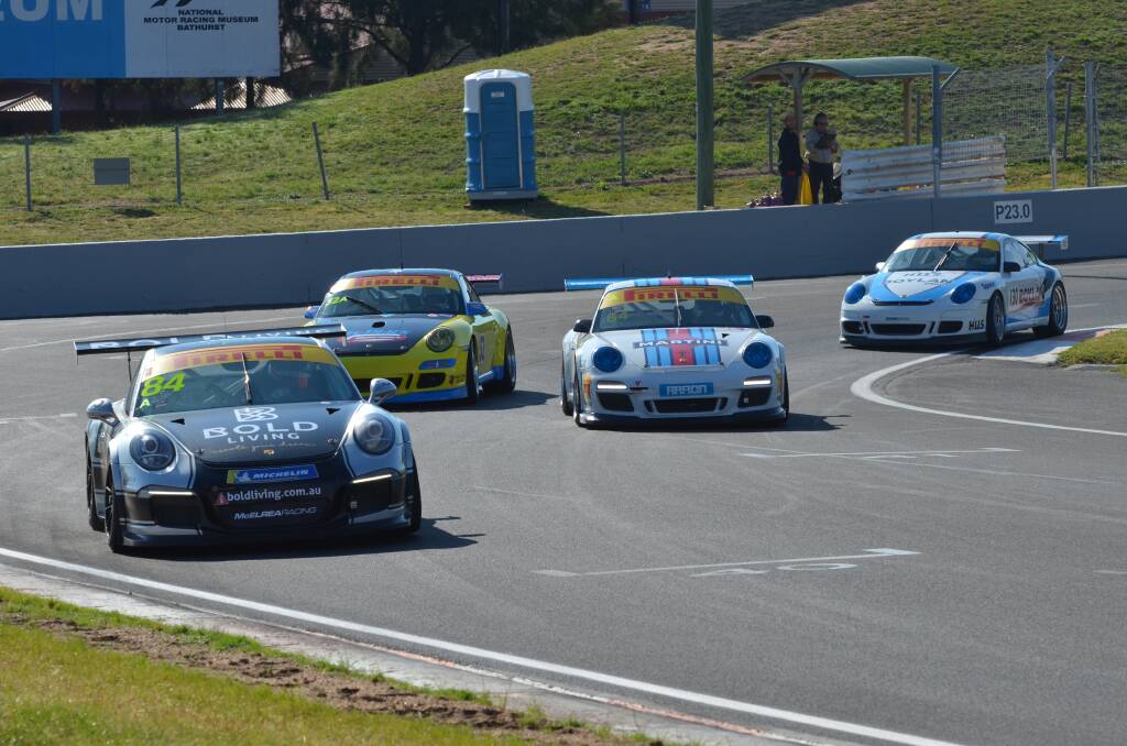 SNAPSHOT: The spotlight was on these Porsches coming around Murray's Corner at Mount Panorama on Thursday. Photo: ANYA WHITELAW