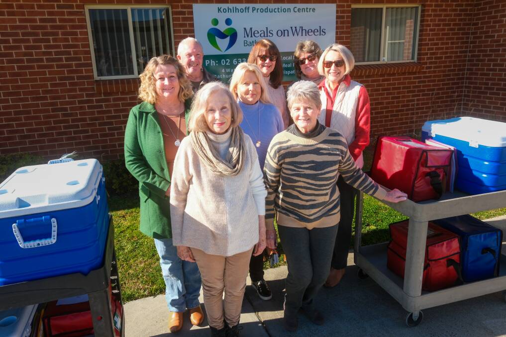 Meals on Wheels Bathurst volunteers Kathy Griffin, Stuart Ellis, Jo Simpson, Sharon Wellings, Margi Byrom, Kathy Gibbs, Kris Turnbull and Jennifer Calvert with meals ready to be loaded into cars. Picture by James Arrow