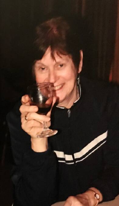 Joan Goldney smiling with a glass in hand. Picture supplied