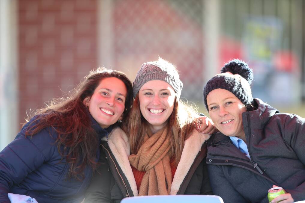 ALL RUGGED UP: Luana Damasceno, Shelly Purcell and Nichole Smeed had a hard time keeping warm while they watched the rugby at Charles Sturt University on Saturday afternoon. Photo: PHIL BLATCH 070718pbcold1