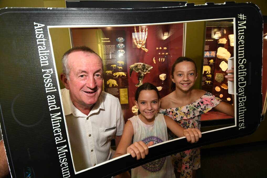 SNAP: Mayor Bobby Bourke with sisters Olivia, 10, and Matildah Board, 12, from Numurkah, Victoria at the fossil museum. Photo: CHRIS SEABROOK