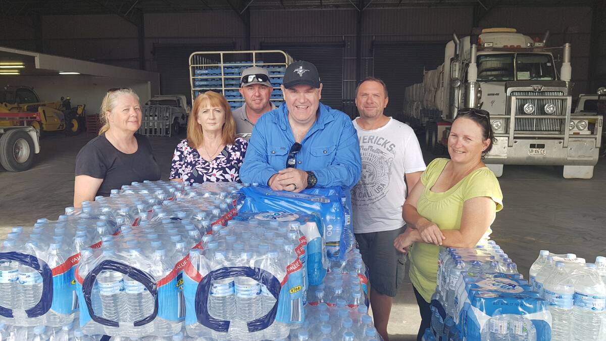 HEROES IN DROUGHT: Corrections officers Kim, Anne, Darren, Chris, Greg and Mel helped to take pallets of water out to Menindee in their own time. 