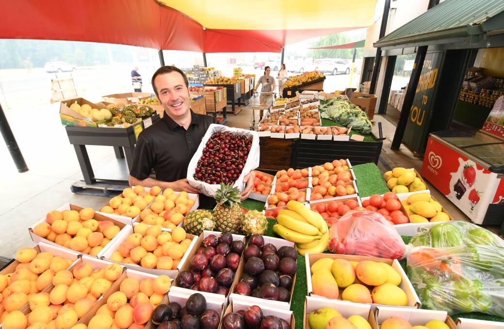 HOT SPOT: Owner of the Kelso Fruit Market, Jason Browne, showing off some of the seasonal stone fruit that people are looking to buy. Photo: CHRIS SEABROOK 122219cjbrowne1