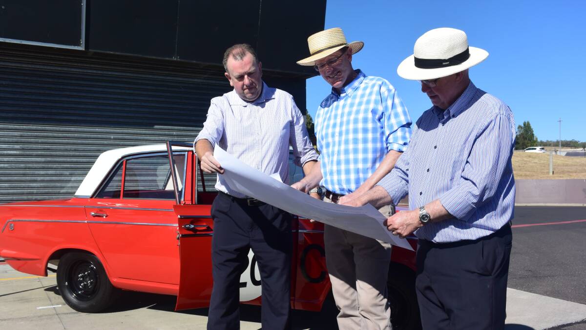PROGRESSING: Bathurst Regional Council's director of Engineering Services, Darren Sturgiss, looking at the concept design for the circuit with member for Calare Andrew Gee and mayor Graeme Hanger. Photo: RACHEL CHAMBERLAIN