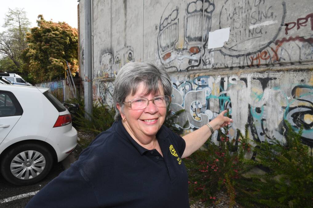 NEW PROJECT: Rotary's Diana Stewart with a section of the wall where graffiti will be removed. Photo: CHRIS SEABROOK 101618cleanup