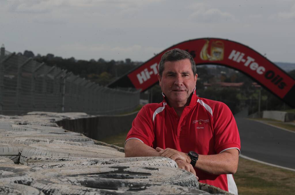 Councillor Warren Aubin standing by a tyre barrier on Mount Panorama. Picture file