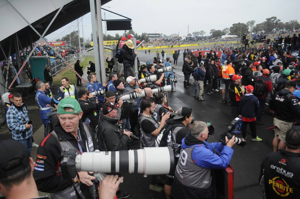 SNAPSHOT: Photographers and fans crowded pit straight on Sunday as they waited for the Bathurst 1000 winners to take their place on the podium. Photo: CHRIS SEABROOK 100817csnaprs