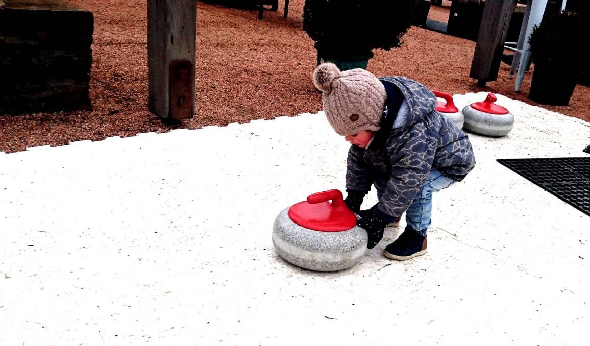 FUN AND GAMES: This child enjoyed the curling activity on offer at Mayfield Garden during the winter festival. Photo: SUPPLIED