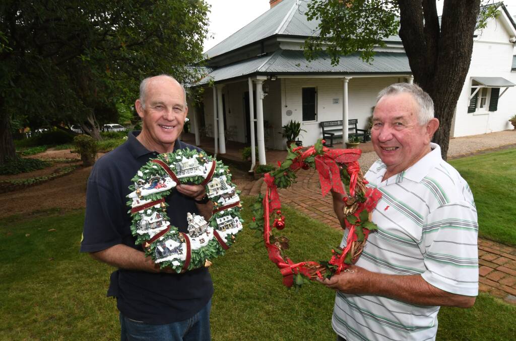 FEELING FESTIVE: Miss Traill's House management committee chairperson Richard Steele with volunteer Tim Cox. Photo: CHRIS SEABROOK 121118cmisst2
