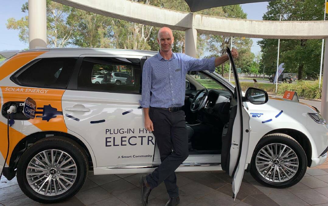 Bathurst Regional Council's environmental officer pictured with the council's sole electric vehicle. 