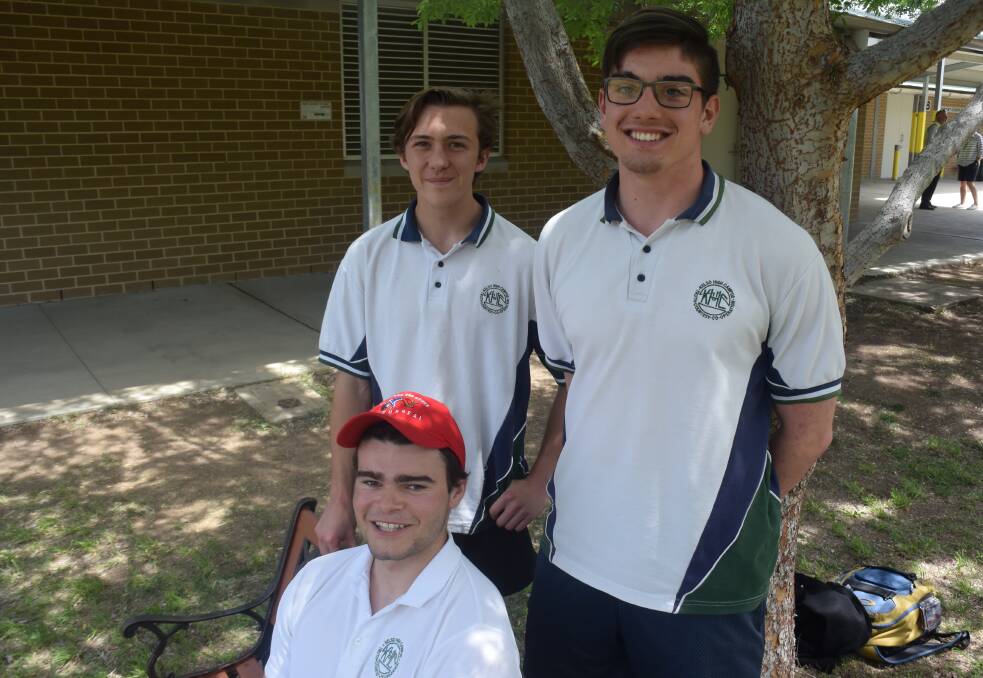 ANOTHER DONE: Curtis Parrington, Jake Parker and Ethan Hamer (seated) after they had completed their physics exam on Thursday. Photo: RACHEL CHAMBERLAIN 110118rchsc
