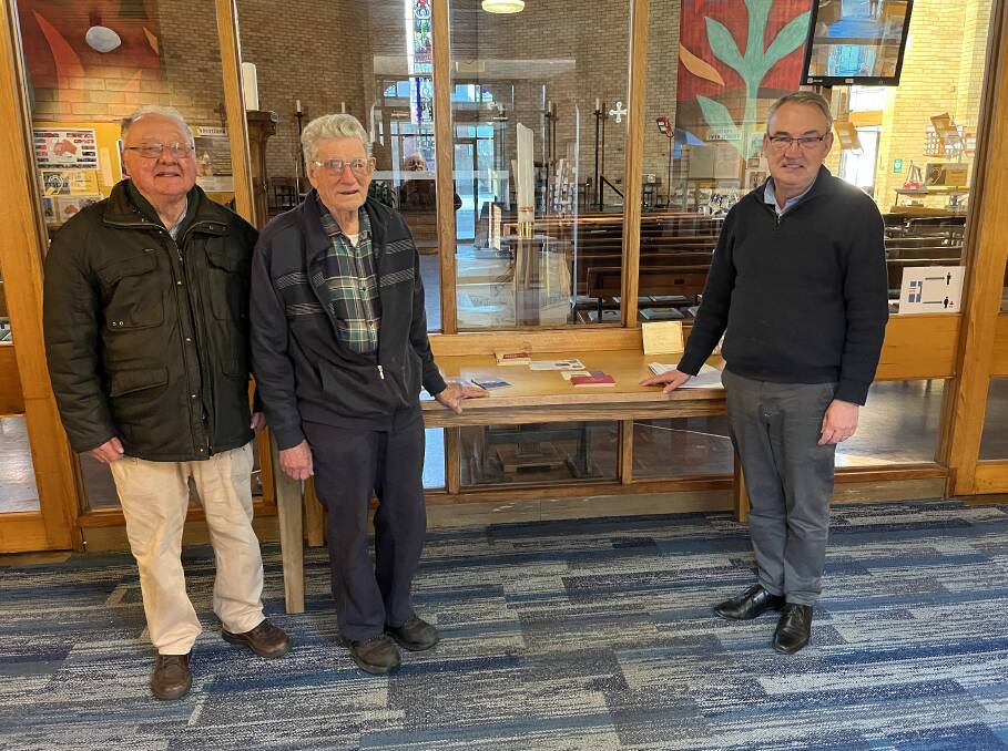 Parish councillor Michael ONeil, woodworker Dick Smith, Anglican Dean James Hodson
standing with the table that Mr Smith made. Picture supplied