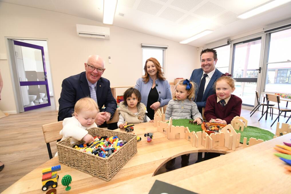 TEST DRIVE: Sofia Issa, 1, Theo Trek, 1, four-year-old Primrose Kensit and Georgie Kensit, 6, playing alongside mayor Graeme Hanger, coordinator Leanne McCurry and local member Paul Toole. Photo: CHRIS SEABROOK 081219cscally2