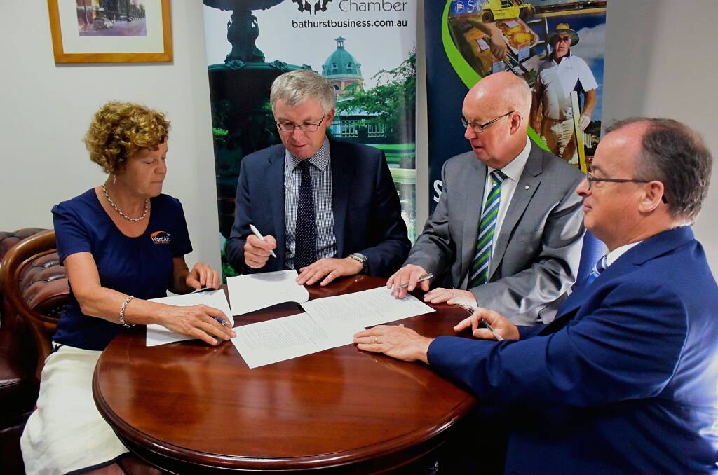 SIGNING: The business chamber's vice president Catherine Fitzsimons and president Angus Edwards, with mayor Graeme Hanger and general manager David Sherley. Photo: RACHEL CHAMBERLAIN 121818rcmou2